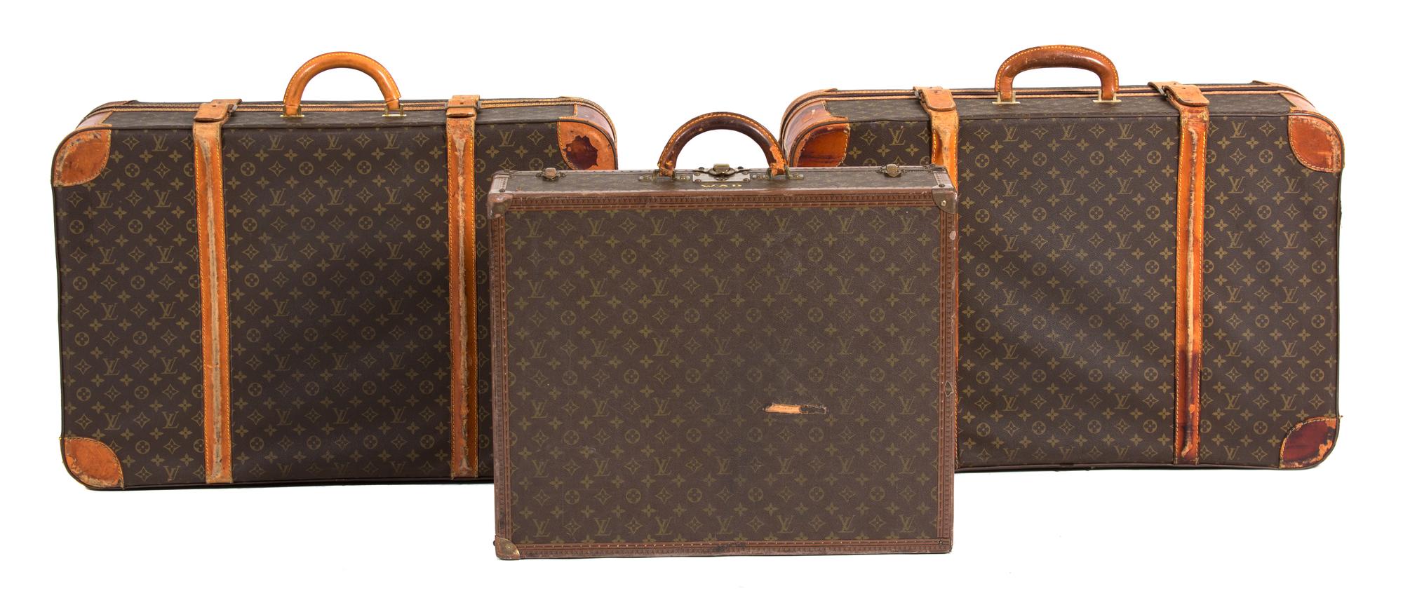 A Group of Three Louis Vuitton Suitcases Largest height 22 x width 30 x depth 10 inches. Hard case 16 x width 24 x depth 6 3/4 inches. — 20TH CENTURY