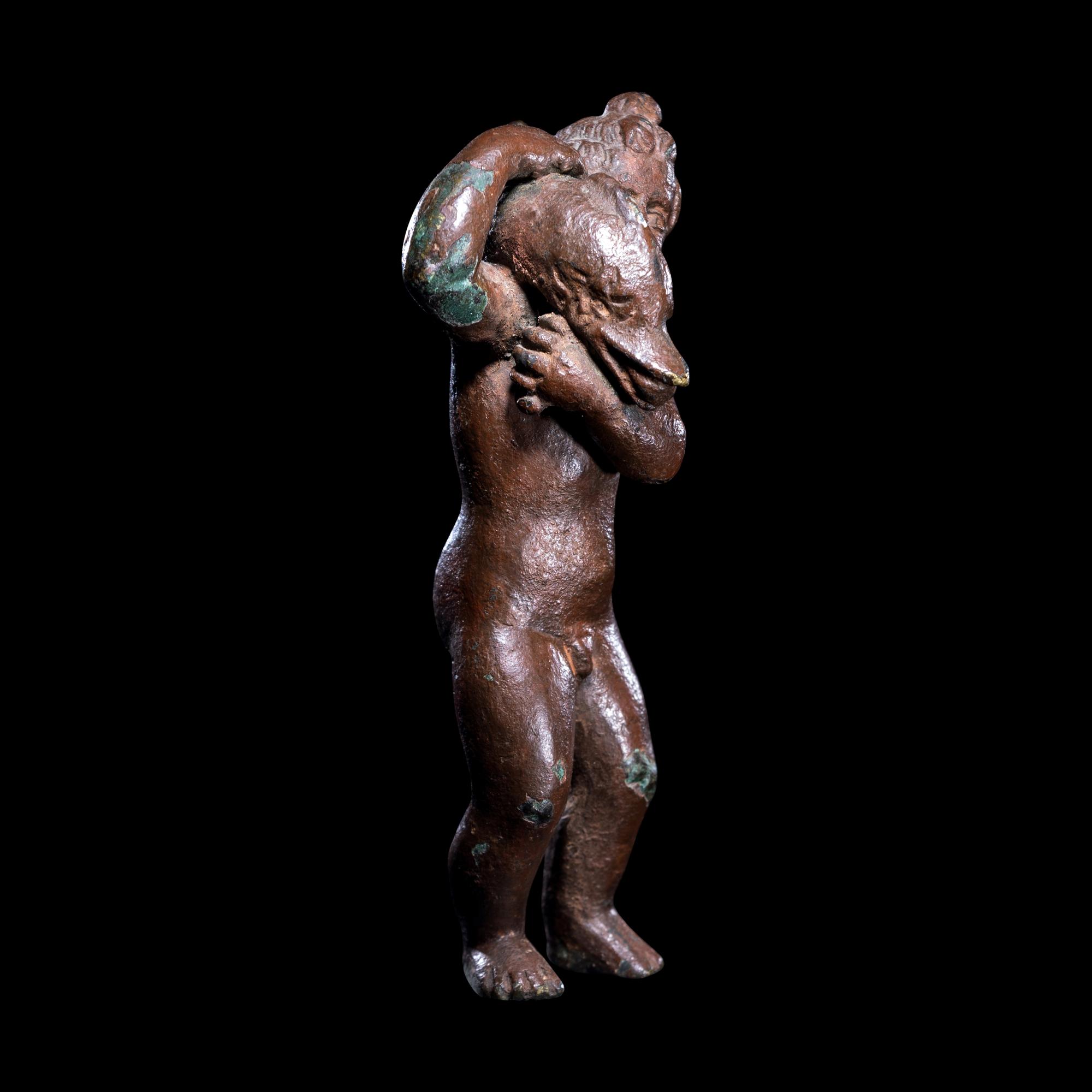 A Roman Bronze Eros with a Dolphin
