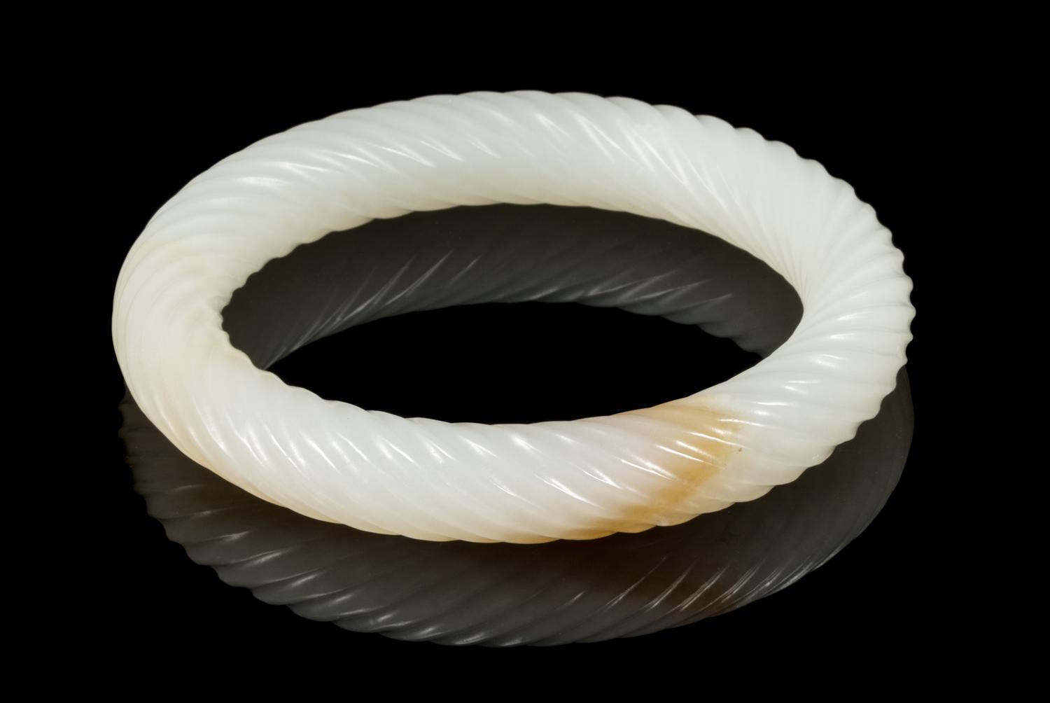 A White and Russet Jade Bangle Interior diameter 2 3/8 inches. — 20TH CENTURY
