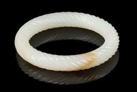 A White and Russet Jade Bangle Interior diameter 2 3/8 inches. — 20TH CENTURY