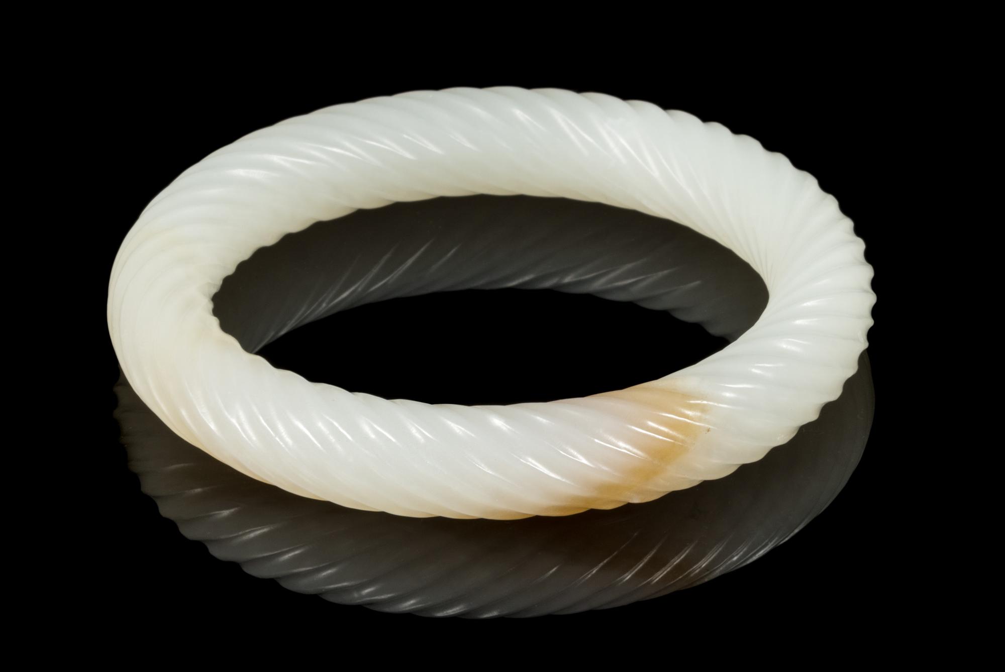 A White and Russet Jade Bangle Interior diameter 2 3/8 inches. — 20TH CENTURY