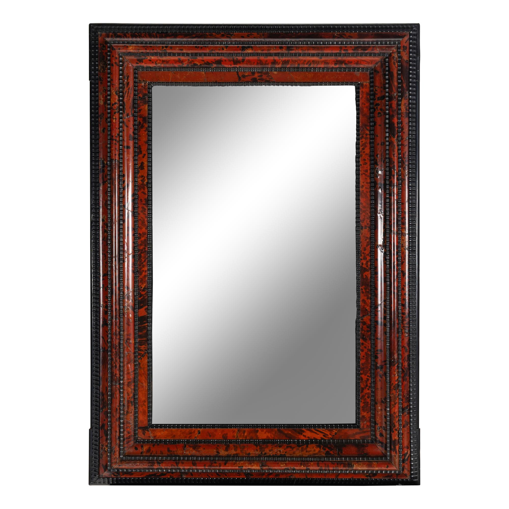 A Flemish Part-Ebonized and Tortoiseshell Veneered Ripple-Molded Mirror
