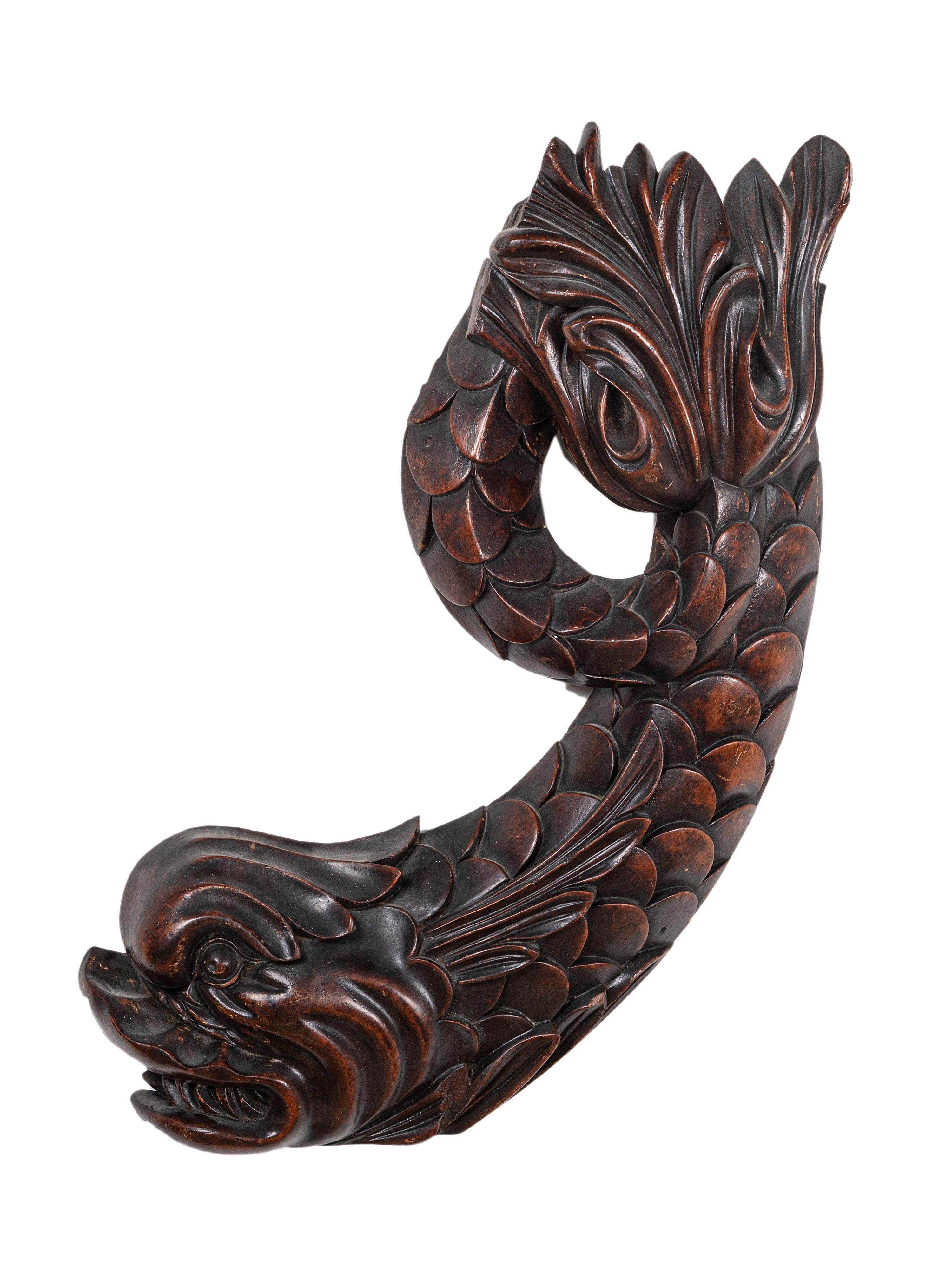 A Pair of Carved Mahogany Dolphin Brackets