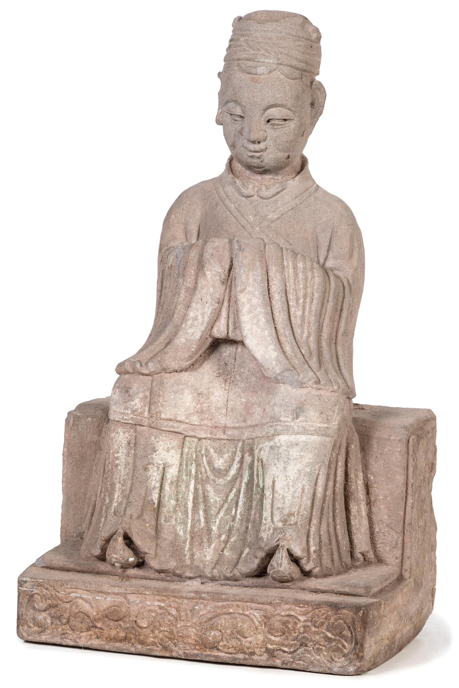 A Carved Stone Buddha Sitting on a Tiered Base