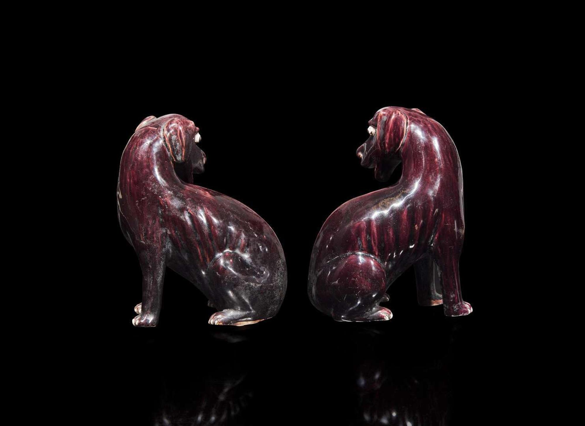 A pair of Chinese export aubergine-glazed porcelain seated dogs, 茄紫釉小狗一對