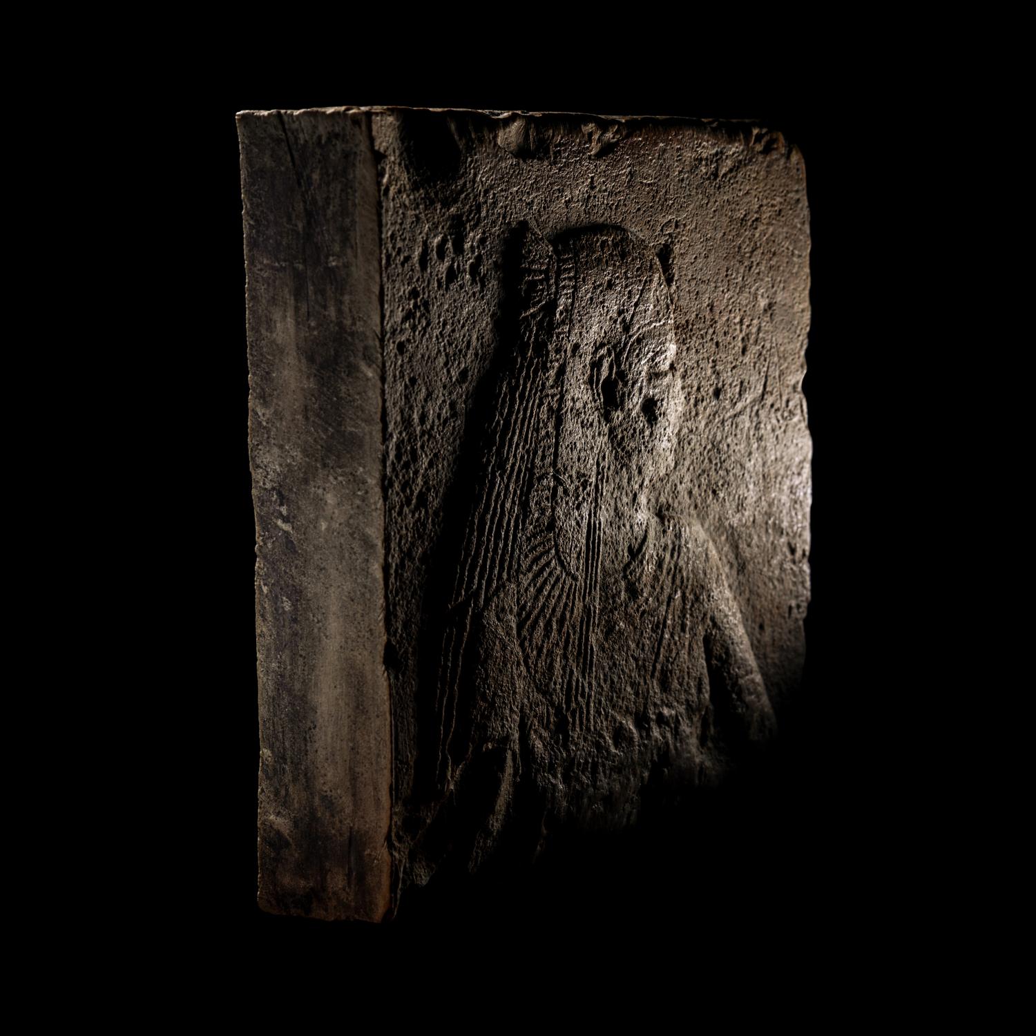 An Egyptian Stone Relief Fragment of a Female Pharaoh or Goddess