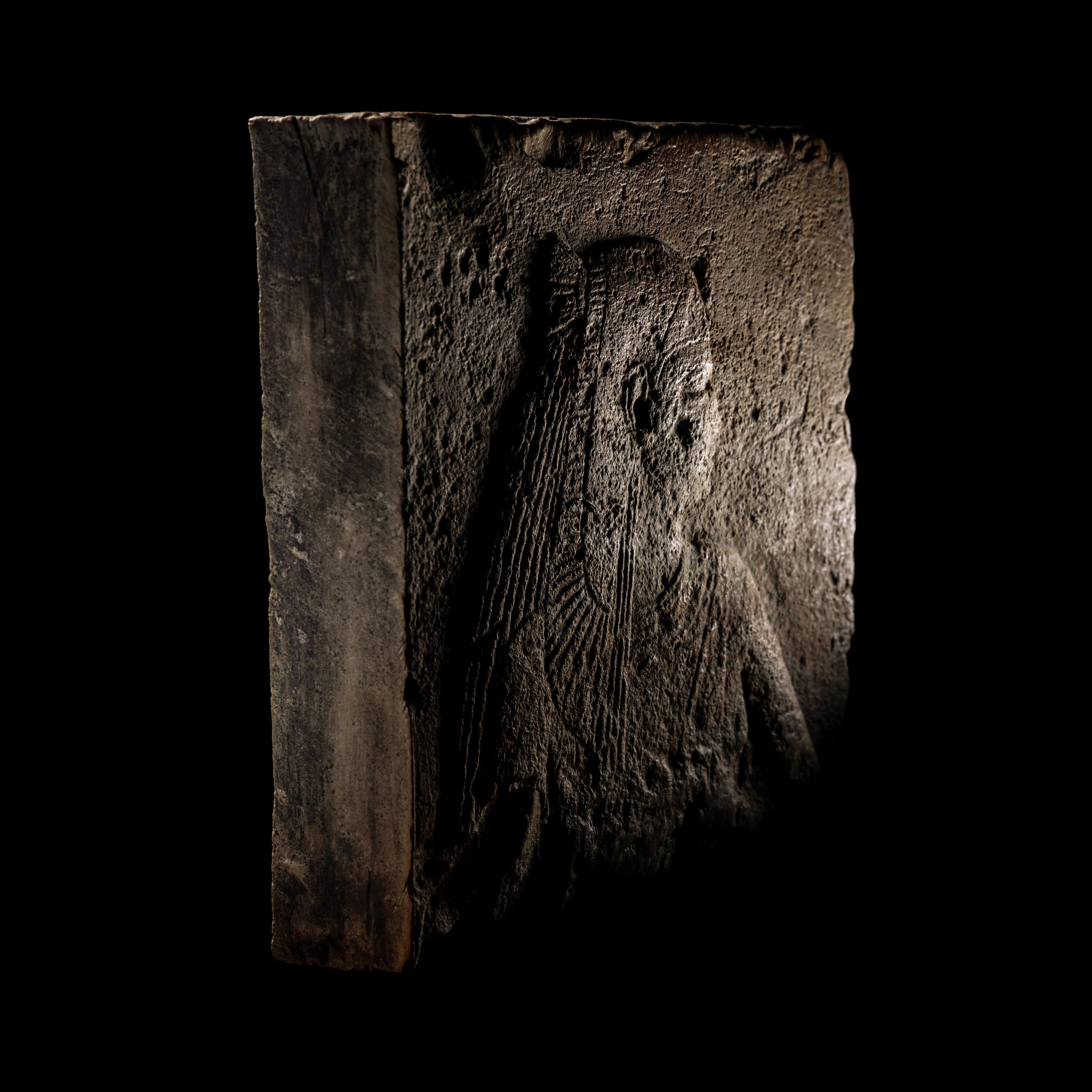 An Egyptian Stone Relief Fragment of a Female Pharaoh or Goddess
