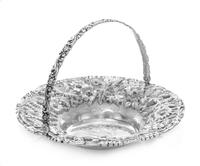 An American Silver Bread Basket, Jenkins & Jenkins Inc., Baltimore, MD, the volute and foliate decorated swivel handle surmounting a re