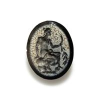 A Roman White Glass Ring Stone with Andromache or Calliope Seated and Holding a Palm Branch