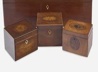 A collection of five George III and Regency inlaid mahogany and satinwood tea caddies and one writing box, late 18th / early 19th century