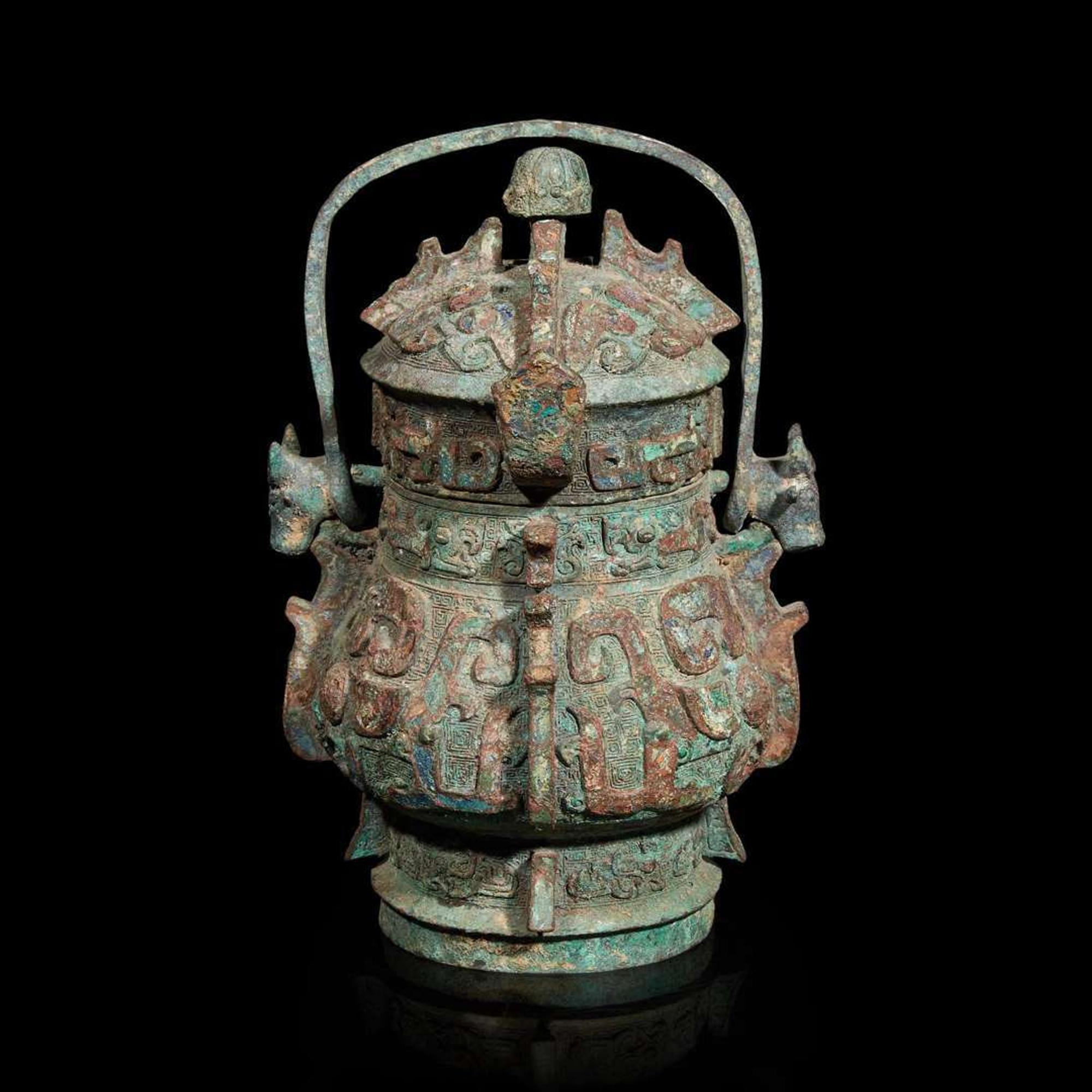 A Chinese archaistic bronze covered ritual wine vessel, You 青銅提梁卣