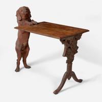 A Black Forest carved walnut and rosewood table with English Labrador Eduard Binder, Brienz, Switzerland, late 19th / early 20th century