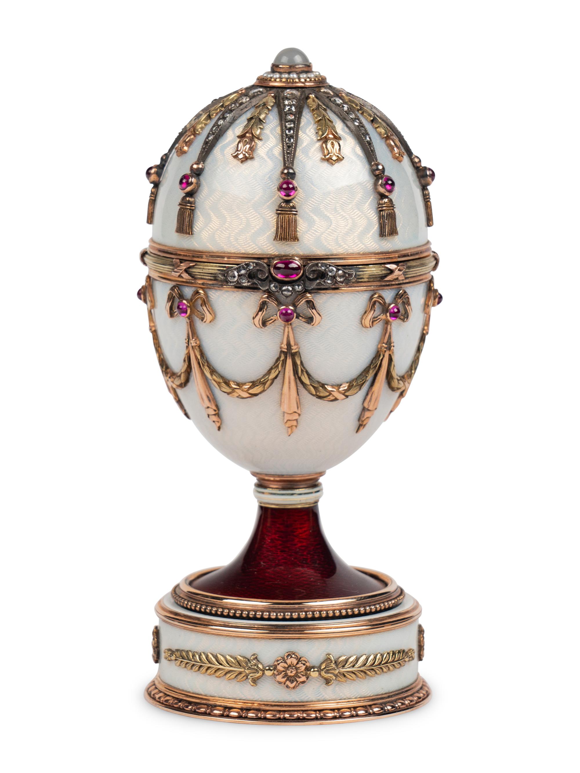 A 14 Karat Vari-Color Gold, Silver, Guilloché Enamel, Diamond, Pearl, and Cabochon Jewel-Mounted Surprise Egg