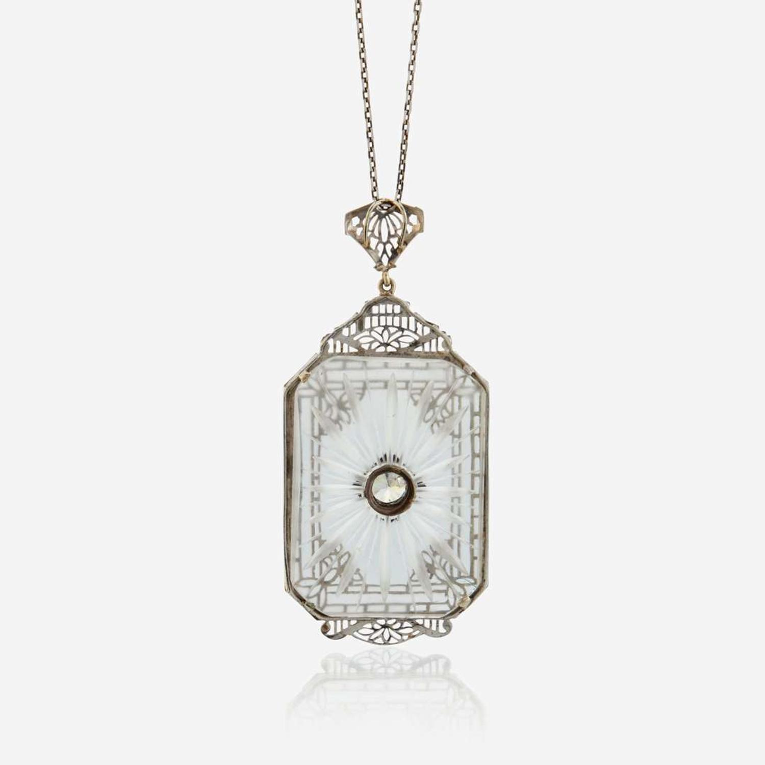 A diamond, rock crystal, and white metal pendant