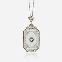 A diamond, rock crystal, and white metal pendant