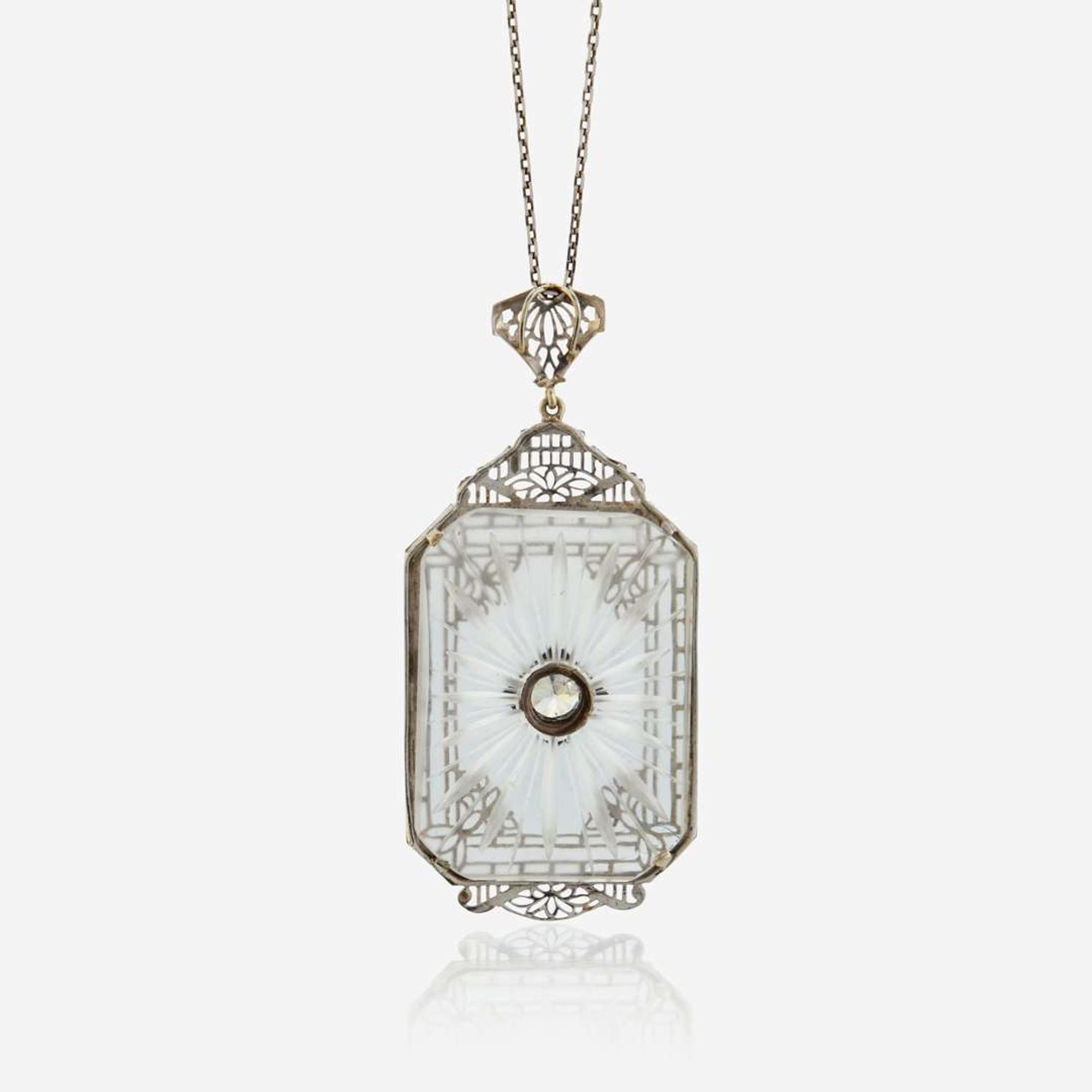 A diamond, rock crystal, and white metal pendant