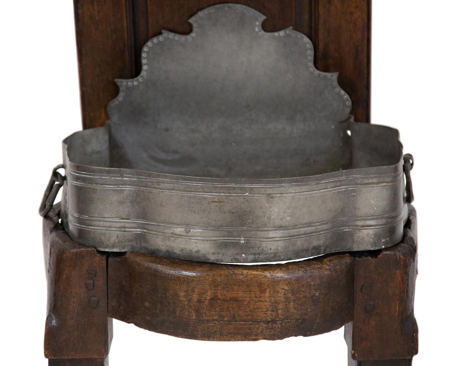 An Italian Carved Walnut Lavabo with Pewter Cistern and Basin