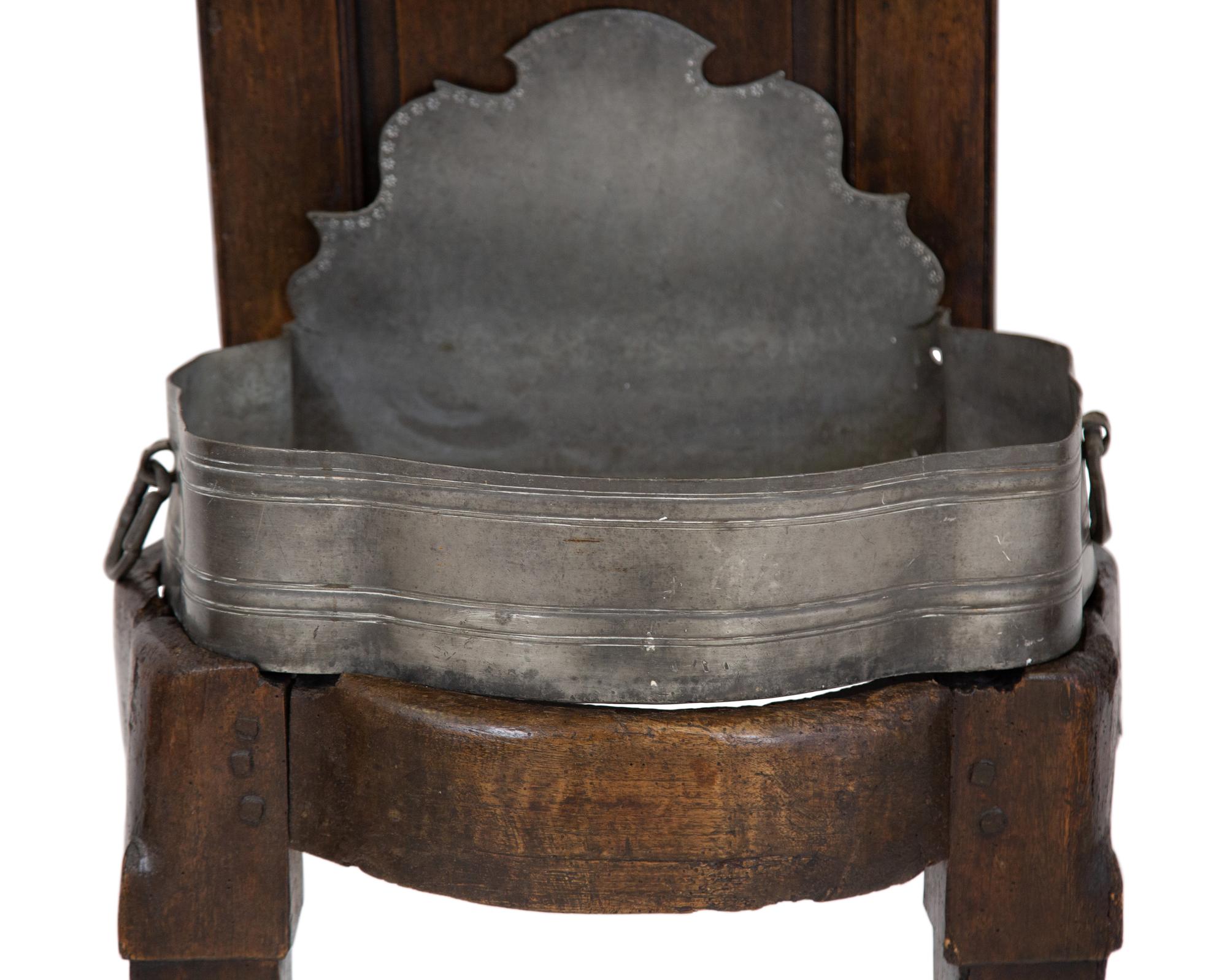 An Italian Carved Walnut Lavabo with Pewter Cistern and Basin