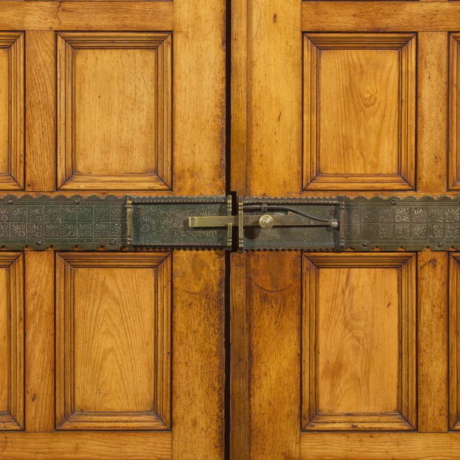 A large English Aesthetic Movement oak wardrobe Attributed to Richard Norman Shaw (1831-1912) & William Eden Nesfield (1835-1888), retailed by Maple & Co. (est. 1841), London, England, circa 1870