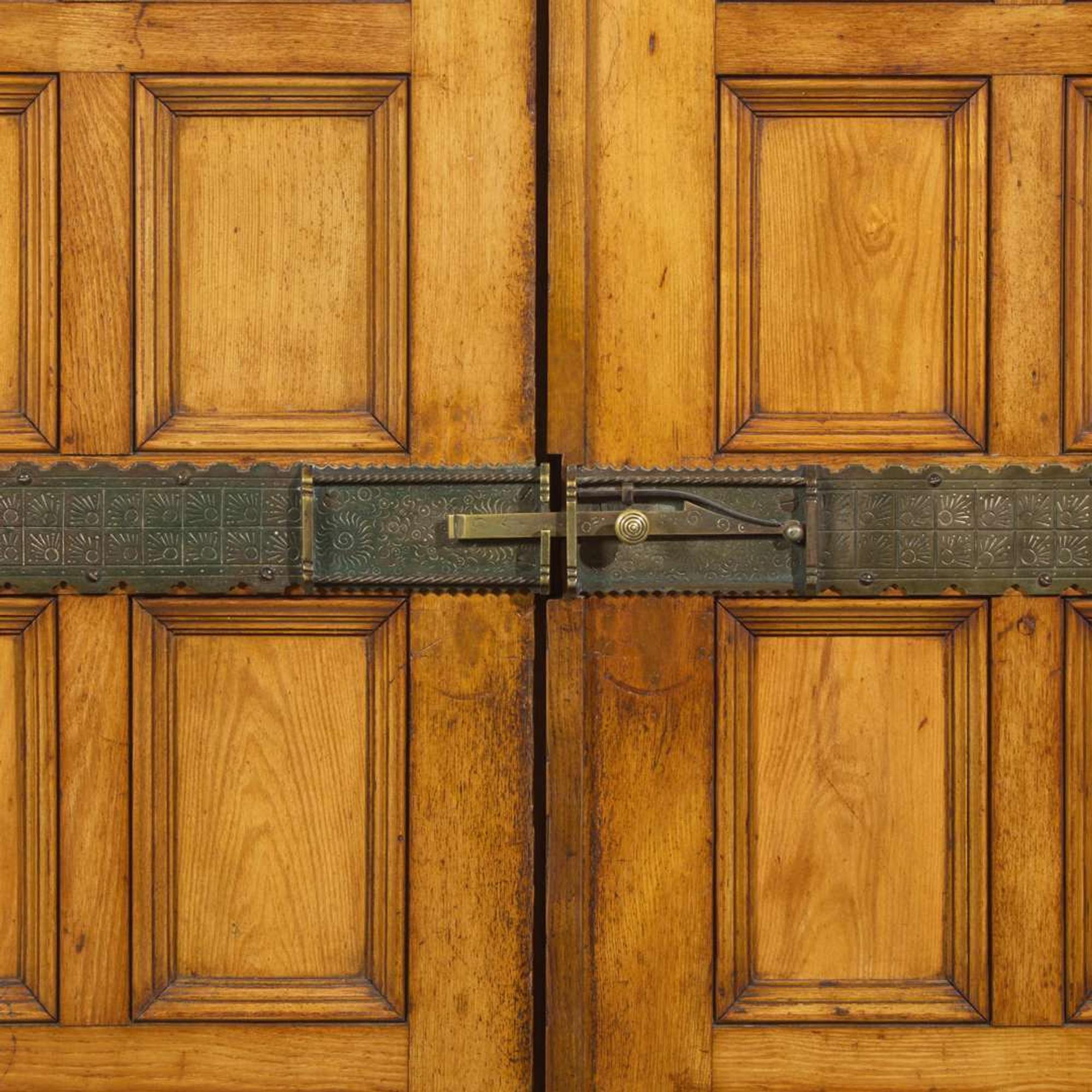 A large English Aesthetic Movement oak wardrobe Attributed to Richard Norman Shaw (1831-1912) & William Eden Nesfield (1835-1888), retailed by Maple & Co. (est. 1841), London, England, circa 1870