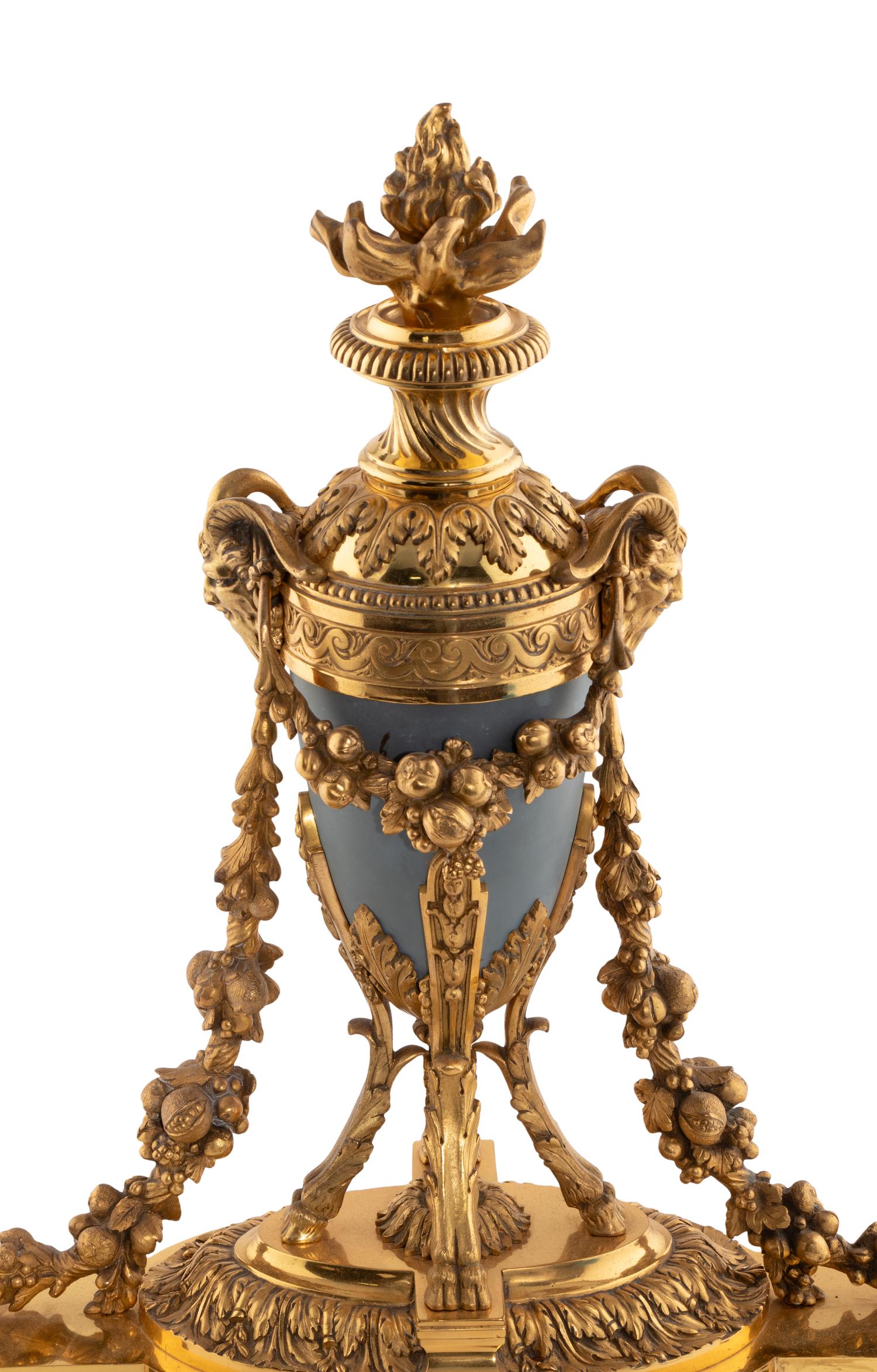 A Pair of French Gilt Bronze and Painted Tole Chenets