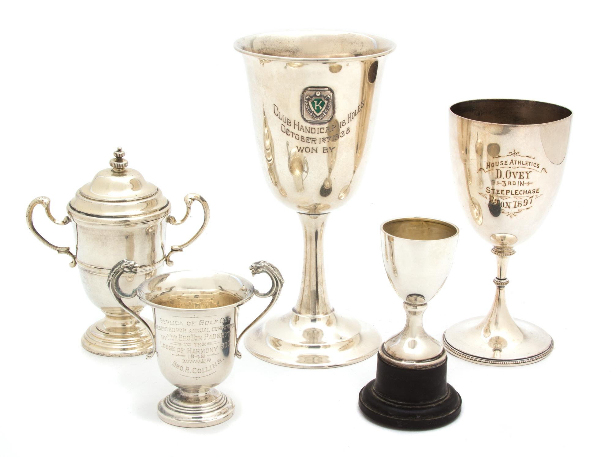 A Collection of Five Silver Trophy Cups, English and American, Various Makers, one mounted on plastic stand