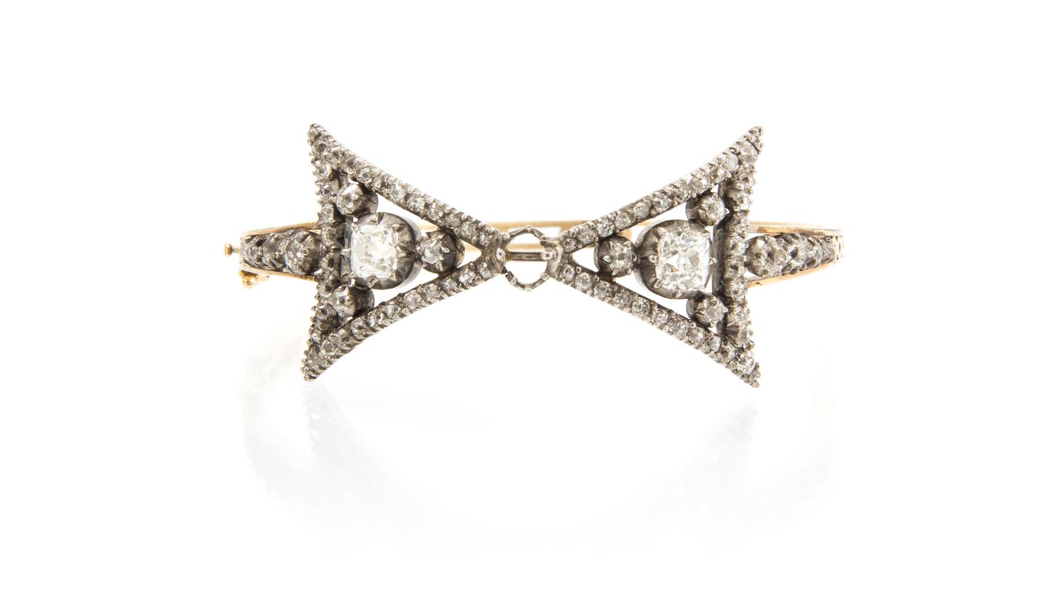A Victorian Silver Topped Gold and Diamond Bow Motif Bangle, 11.10 dwts.