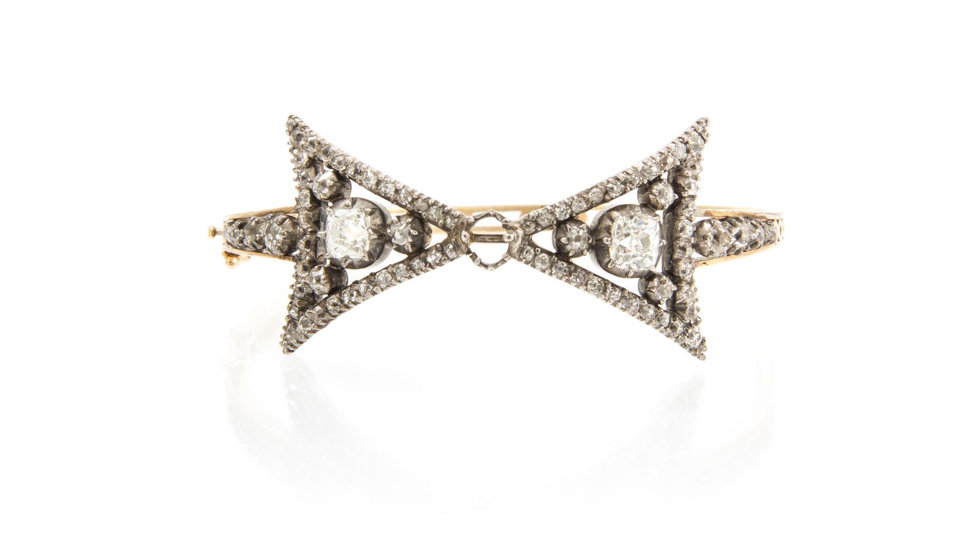 A Victorian Silver Topped Gold and Diamond Bow Motif Bangle, 11.10 dwts.