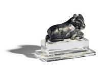 A Mesopotamian Mottled Black Stone Recumbent Bull Amulet