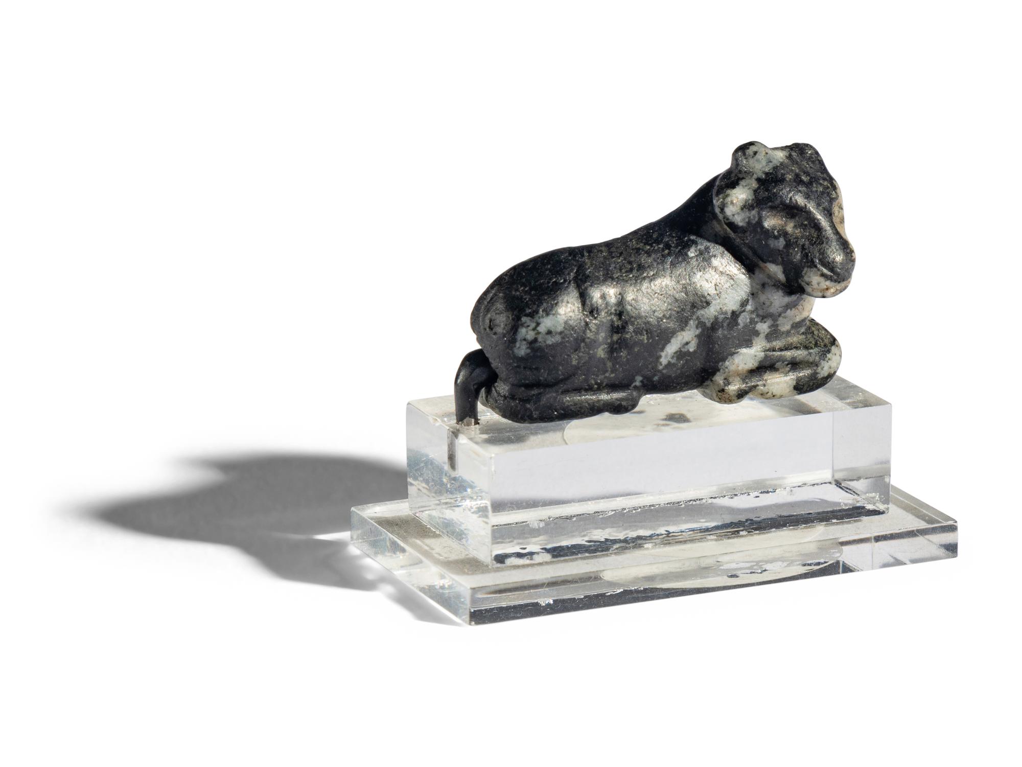 A Mesopotamian Mottled Black Stone Recumbent Bull Amulet