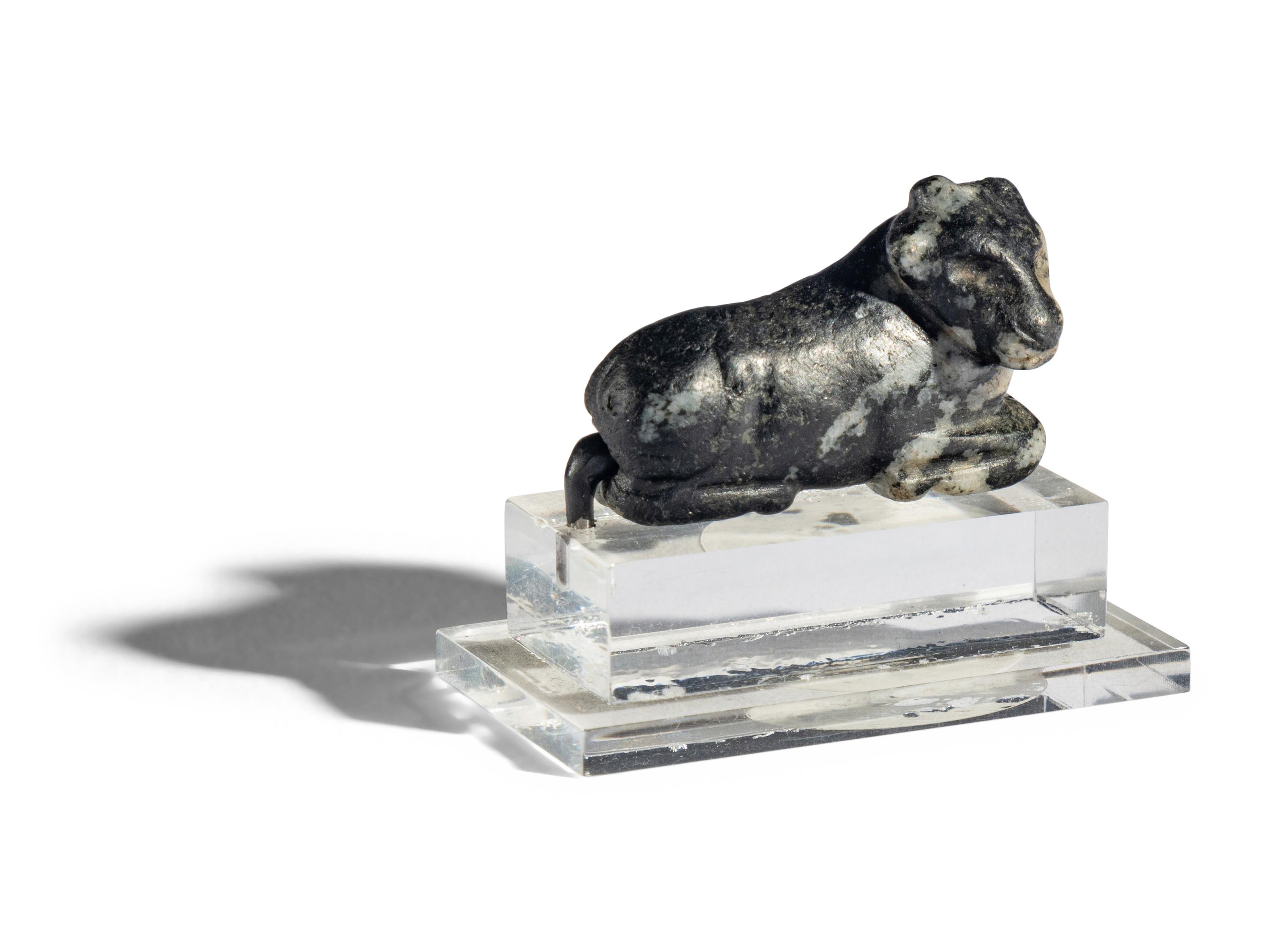 A Mesopotamian Mottled Black Stone Recumbent Bull Amulet