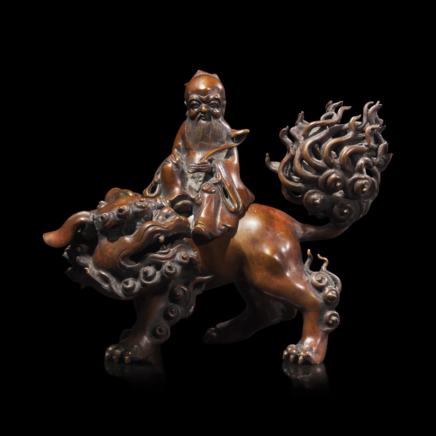 A Patinated Bronze Daoist Immortal Incense Burner, Late 19th Century 19世紀末 仙人乘獅銅香薰