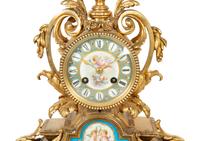 A French Gilt Bronze and Sèvres Porcelain Clock Garniture