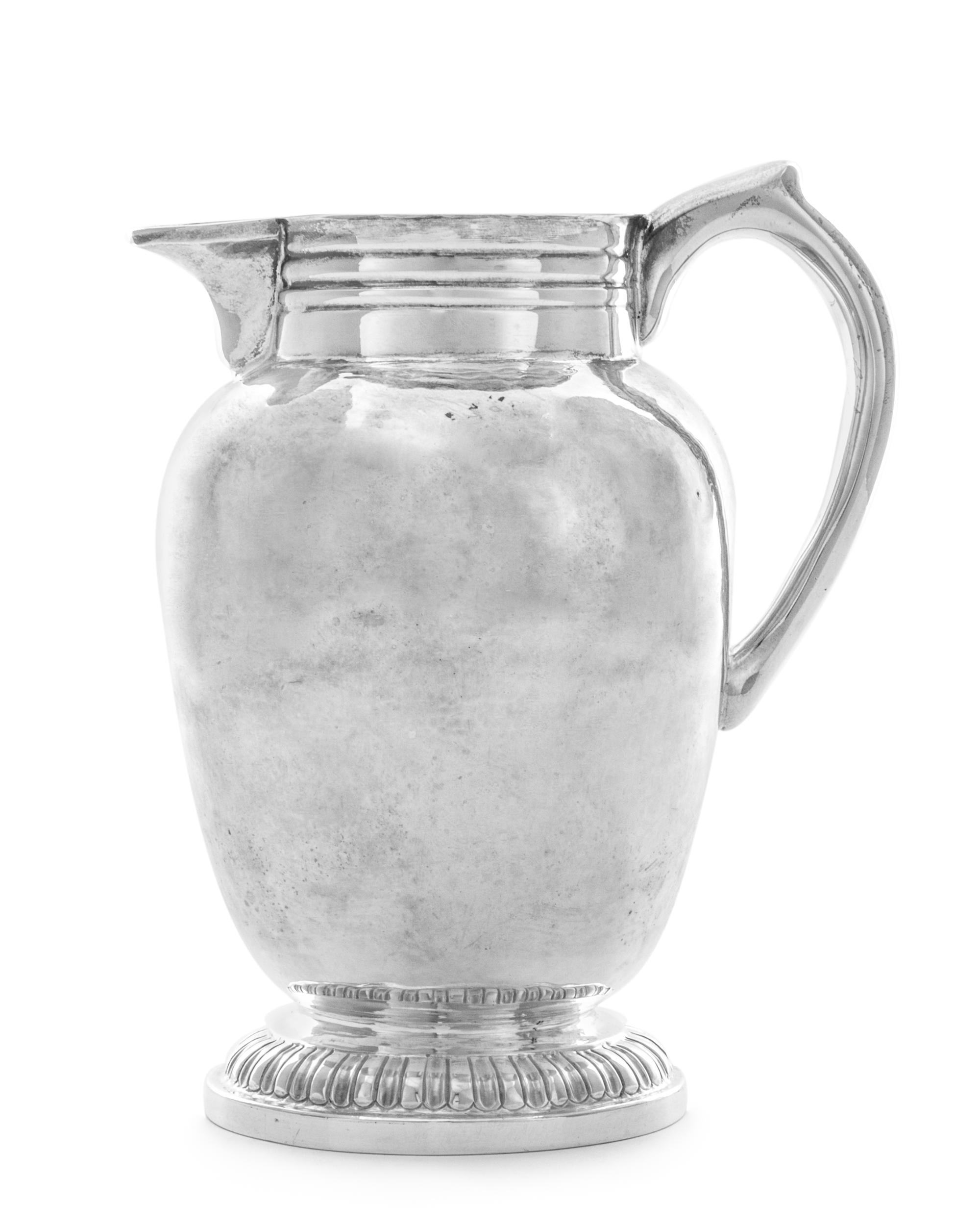 A George I Silver Pitcher, Joseph Clare, London, 1715, the baluster form body having a ribbed neck, raised on a circular foot.