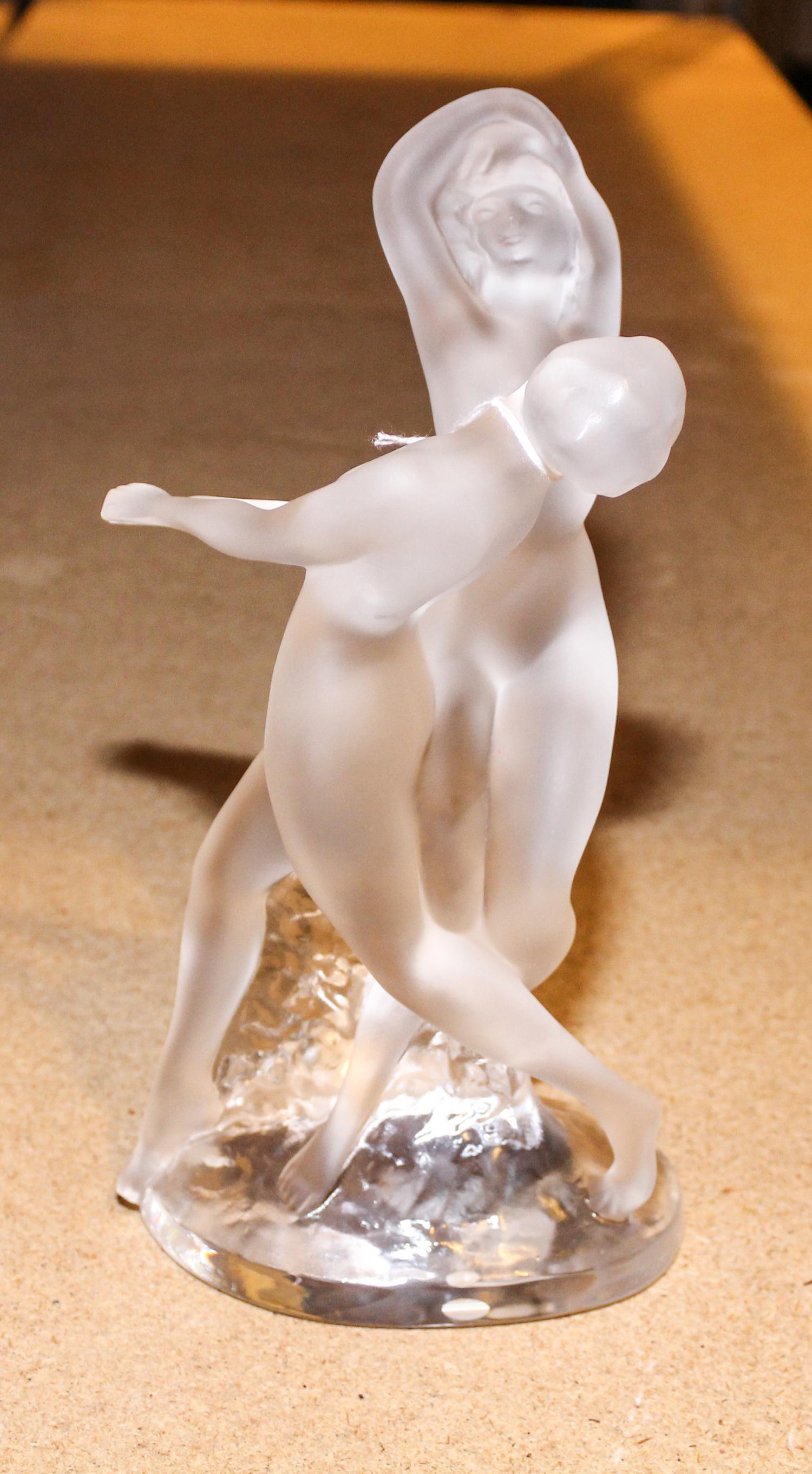 A Lalique Molded and Frosted Glass Figural Group. Height 10 1/8 inches.