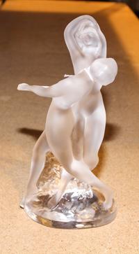 A Lalique Molded and Frosted Glass Figural Group. Height 10 1/8 inches.