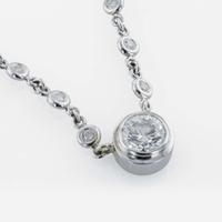 A 14K, white gold diamond bezel set necklace