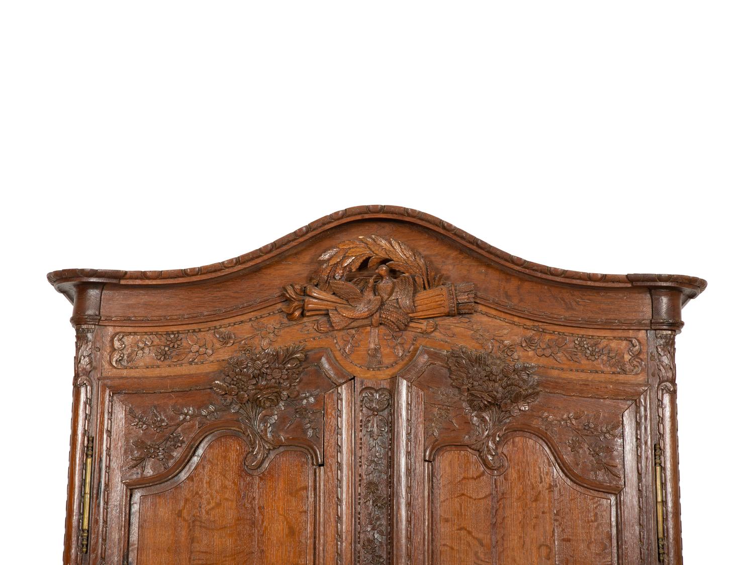 A French Provincial Carved Oak Armoire
