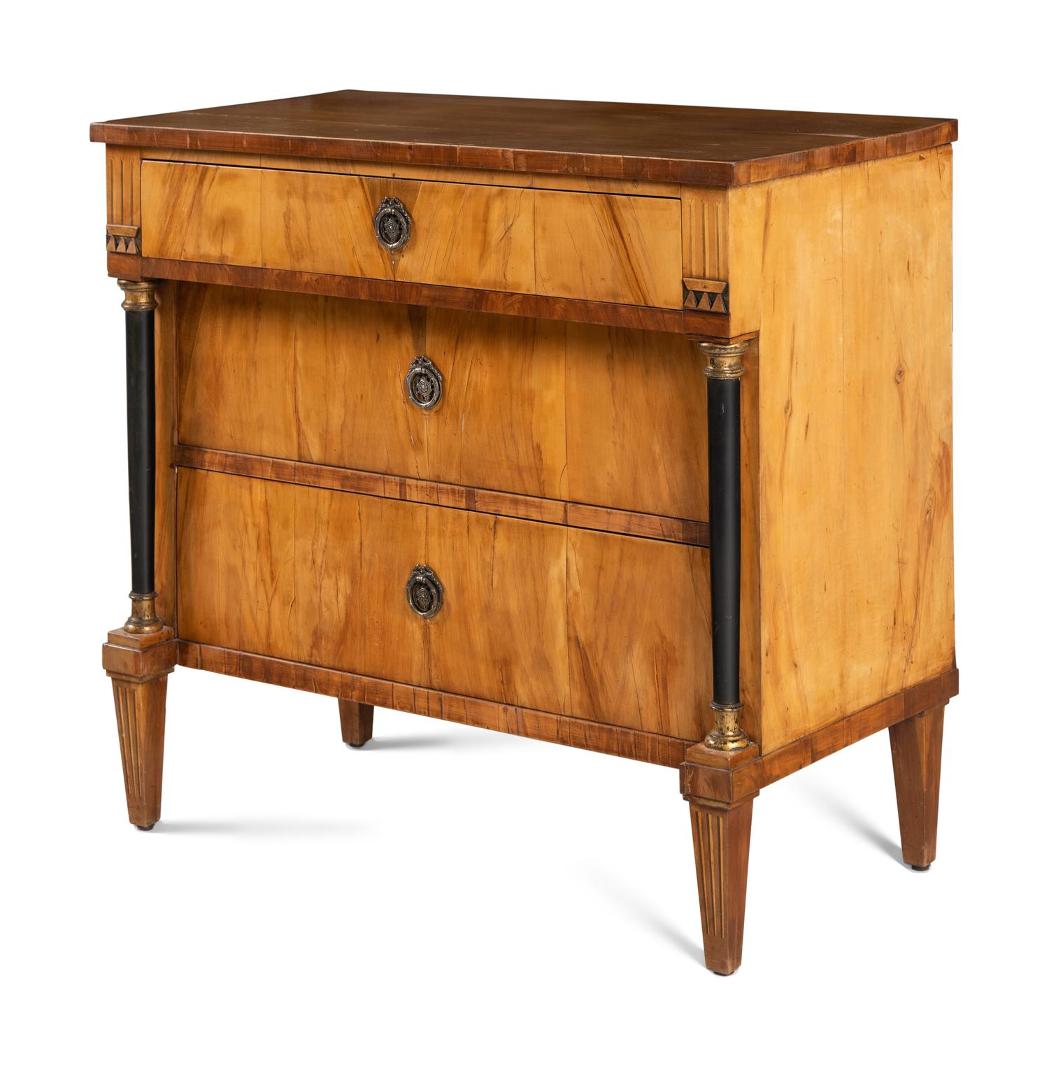 A Biedermeier Walnut and Parcel Ebonized Commode
