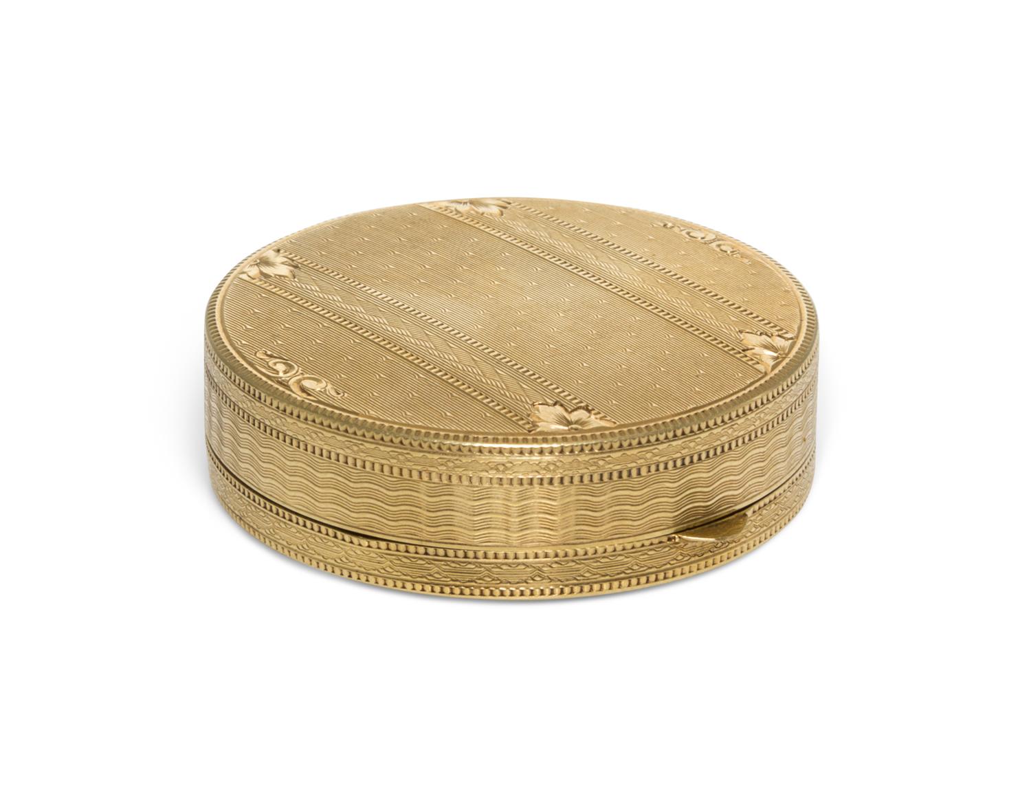 A 14 Karat Yellow Gold Pill Box, 20th Century, of circular form with an engine turned edge.