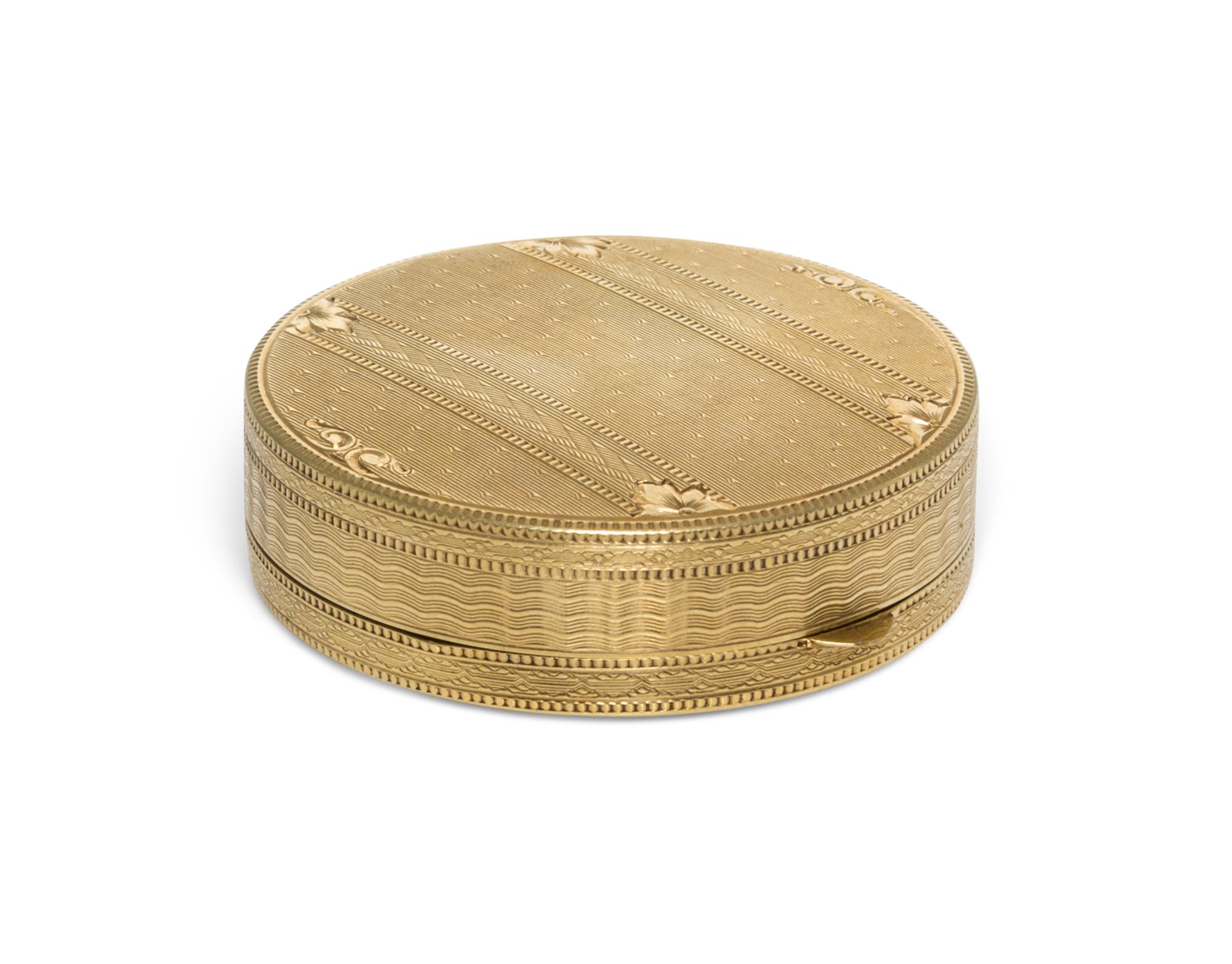 A 14 Karat Yellow Gold Pill Box, 20th Century, of circular form with an engine turned edge.