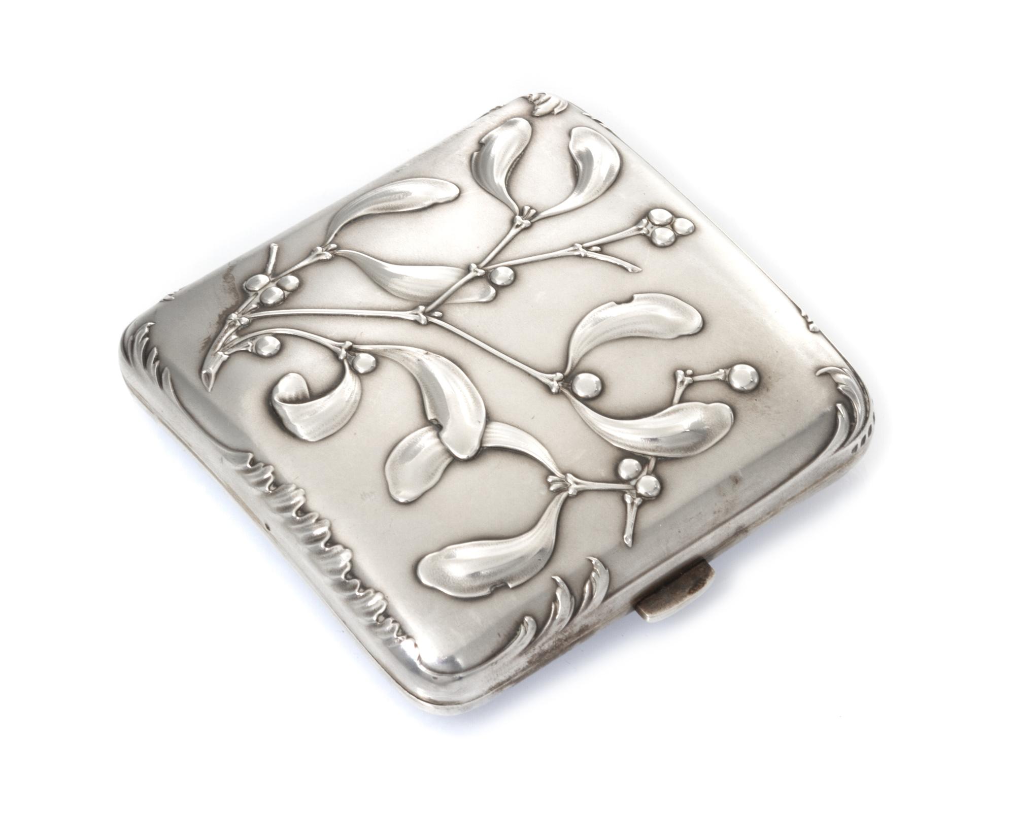 A French Art Nouveau Silver Cigarette Case, Maker's mark obscured, of square form, the case worked with foliate and berry motifs.