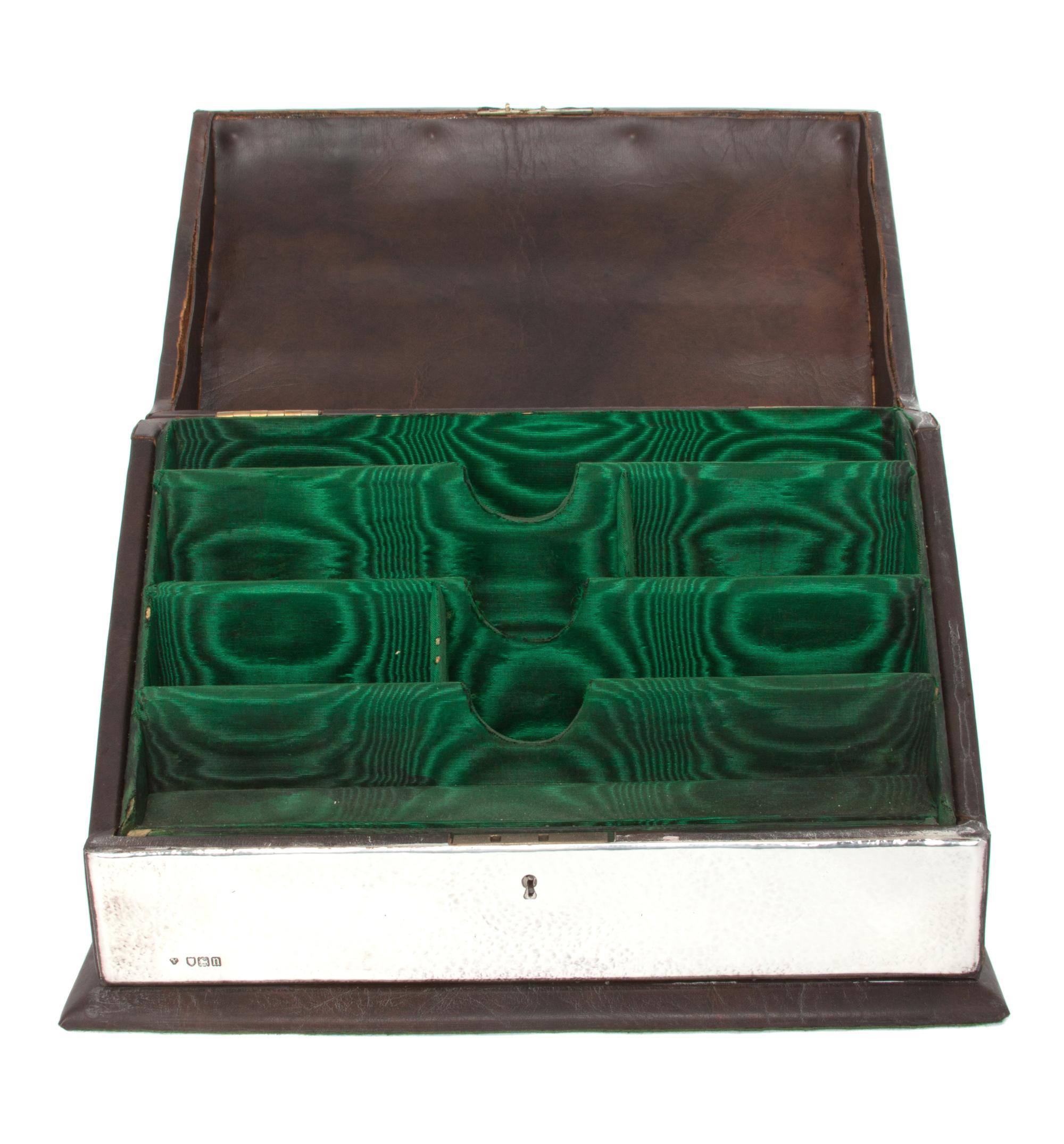 An Edwardian Silver Stationery Box, Holland, Aldwinckle & Slater, London, 1908-09, with spot hammered surfaces, the hinged lid decorate