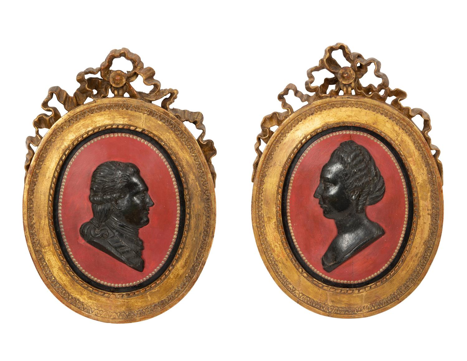 A Pair of Giltwood Framed Ebonized Relief Portrait Plaques of French Nobility, 18th Century