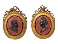 A Pair of Giltwood Framed Ebonized Relief Portrait Plaques of French Nobility, 18th Century