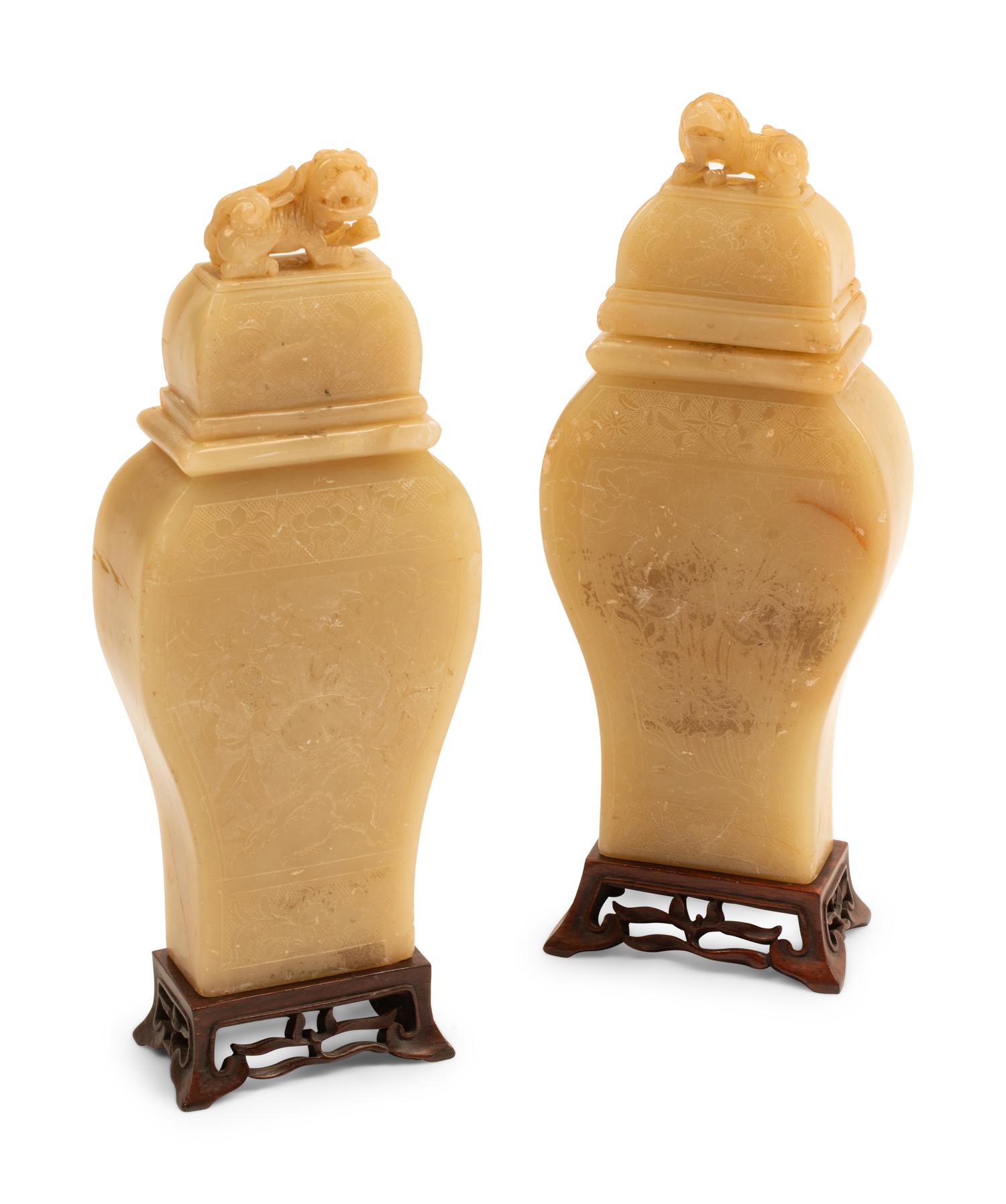 A Pair of Chinese Carved White Stone Jars on Wood Bases