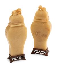 A Pair of Chinese Carved White Stone Jars on Wood Bases