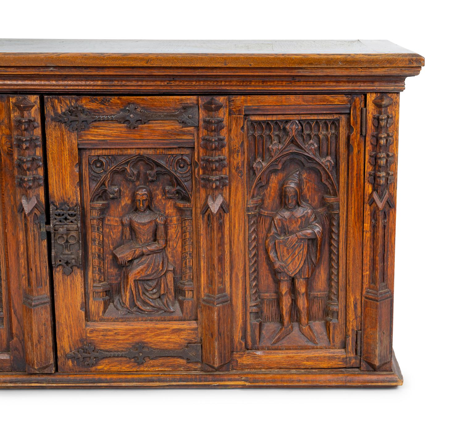 A Renaissance Revival Carved Oak Trunk with Iron Mounts — 19TH/20TH CENTURY