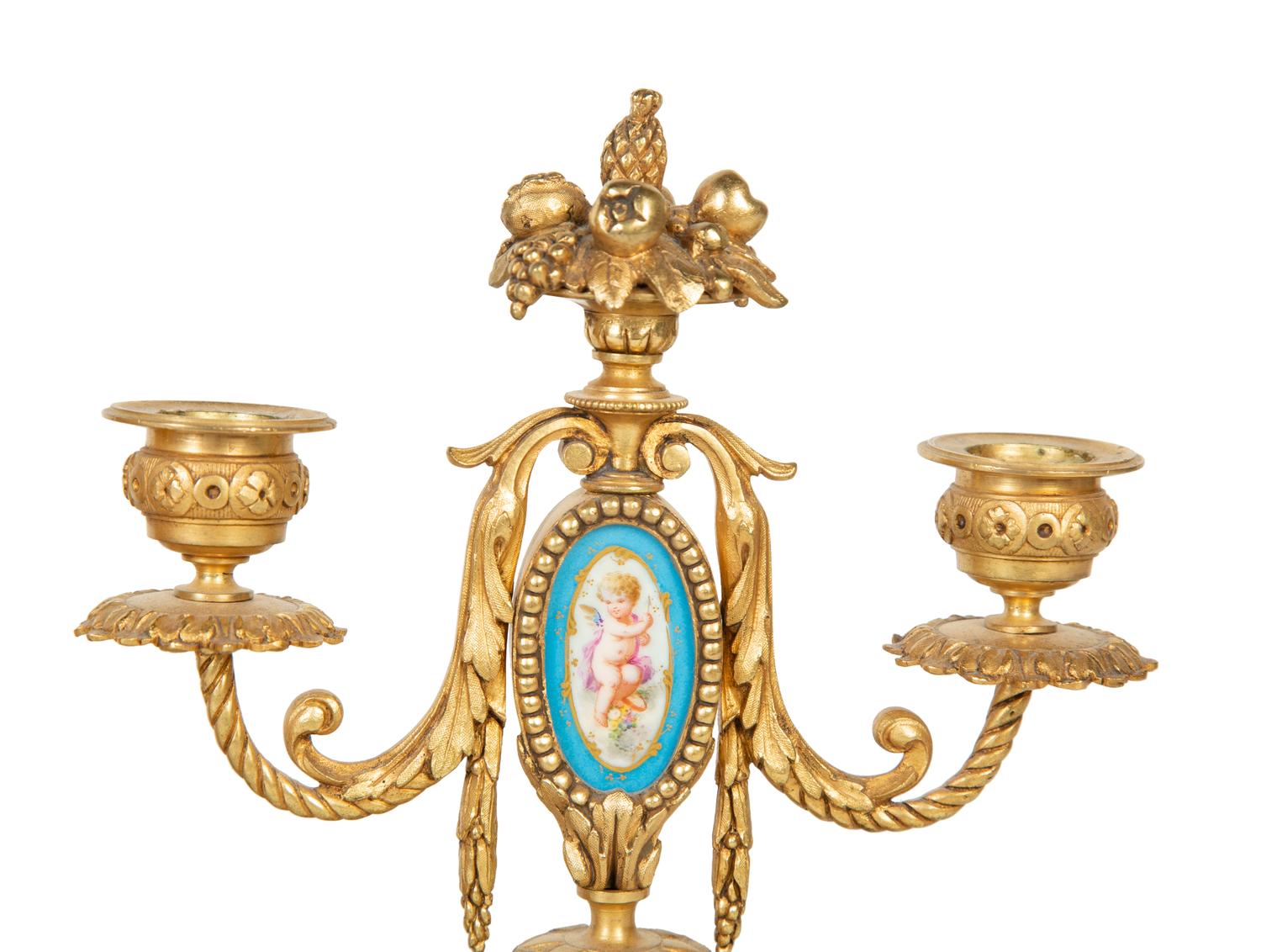 A French Gilt Bronze and Sèvres Porcelain Clock Garniture