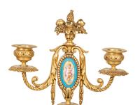 A French Gilt Bronze and Sèvres Porcelain Clock Garniture